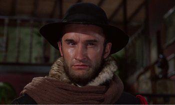 Movie still from “Django” (1966), directed by Sergio Corbucci – A person wearing a hat and a scarf; Close Up shot, Low angle