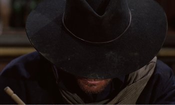 Movie still from “Django” (1966), directed by Sergio Corbucci – A person wearing a cowboy hat; Extreme Close Up shot, Low angle