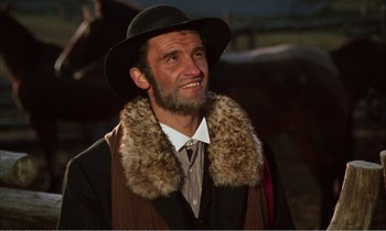 Movie still from “Django” (1966), directed by Sergio Corbucci – A man with a beard wearing a hat and a fur collar; Close Up shot, Low angle