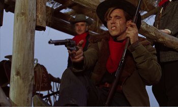 Movie still from “Django” (1966), directed by Sergio Corbucci – Two men dressed in old western clothing and holding guns; Medium shot, Low angle