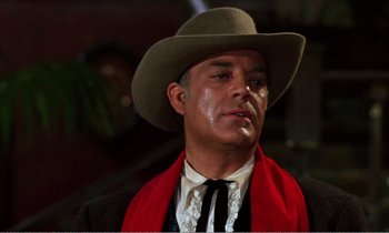 Movie still from “Django” (1966), directed by Sergio Corbucci – A man wearing a cowboy hat and a red scarf; Close Up shot, Low angle