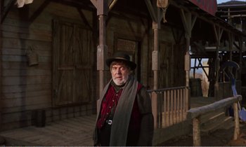 Movie still from “Django” (1966), directed by Sergio Corbucci – An older man wearing a hat and a scarf; Medium shot, Low angle