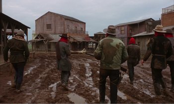 Movie still from “Django” (1966), directed by Sergio Corbucci – A group of men standing on top of a muddy field; Wide shot, Low angle