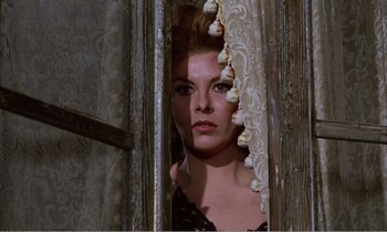 Movie still from “Django” (1966), directed by Sergio Corbucci – A woman standing in a doorway looking at the camera; Close Up shot, Low angle