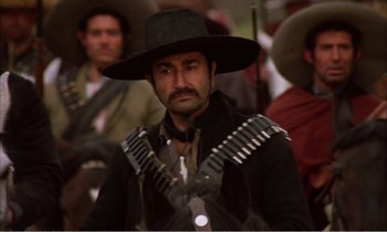 Movie still from “Django” (1966), directed by Sergio Corbucci – A man in a black hat and a black jacket; Close Up shot, Low angle