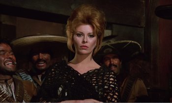 Movie still from “Django” (1966), directed by Sergio Corbucci – A woman in a black dress with two men in the background; Medium shot, Low angle