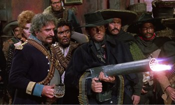 Movie still from “Django” (1966), directed by Sergio Corbucci – A group of men standing next to each other holding guns; Medium shot, Low angle