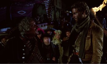 Movie still from “Django” (1966), directed by Sergio Corbucci – A group of people standing in a room; Medium shot, Over the shoulder angle