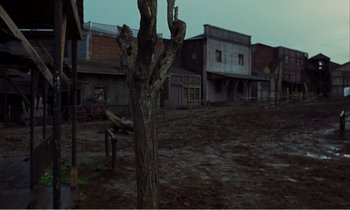 Movie still from “Django” (1966), directed by Sergio Corbucci – A tree in the middle of an abandoned town; Extreme Wide shot, High angle