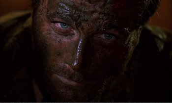Movie still from “Django” (1966), directed by Sergio Corbucci – A man's face covered in mud; Close Up shot, Overhead angle