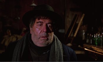 Movie still from “Django” (1966), directed by Sergio Corbucci – An older man wearing a hat and a scarf; Close Up shot, Over the shoulder angle