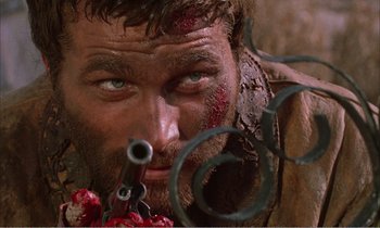 Movie still from “Django” (1966), directed by Sergio Corbucci – A man's face with blood on his face; Close Up shot, Low angle