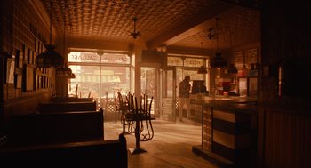 Movie still from “Do the Right Thing” (1989), directed by Spike Lee – An empty restaurant with a person sitting at a table; Wide shot, High angle