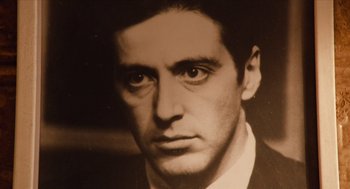 Movie still from “Do the Right Thing” (1989), directed by Spike Lee – A black - and - white photo of a man in a suit; Extreme Close Up shot, Low angle