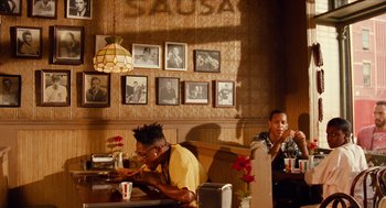 Movie still from “Do the Right Thing” (1989), directed by Spike Lee – Two men sitting at a table in a restaurant; Wide shot, Low angle