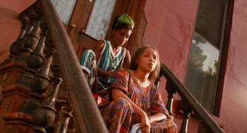 Movie still from “Do the Right Thing” (1989), directed by Spike Lee – Two young women sitting on the steps of a building; Medium shot, Low angle