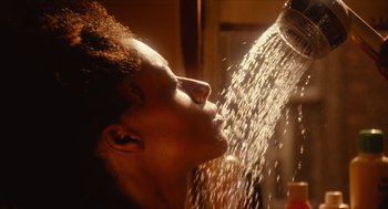 Movie still from “Do the Right Thing” (1989), directed by Spike Lee – A woman is taking a shower in the bathroom; Extreme Close Up shot, Low angle