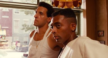 Movie still from “Do the Right Thing” (1989), directed by Spike Lee – A couple of men standing next to each other; Close Up shot, Low angle