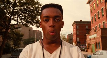 Movie still from “Do the Right Thing” (1989), directed by Spike Lee – A man with a beard and a white t - shirt; Close Up shot, Low angle
