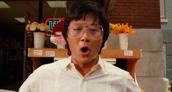 Movie still from “Do the Right Thing” (1989), directed by Spike Lee – A young man wearing glasses and a white shirt; Close Up shot, Low angle