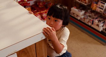 Movie still from “Do the Right Thing” (1989), directed by Spike Lee – A little girl sitting at a table in a kitchen; Close Up shot, High angle
