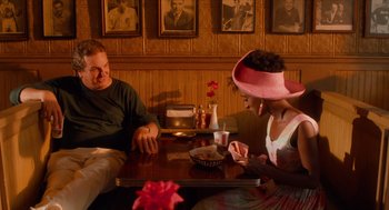 Movie still from “Do the Right Thing” (1989), directed by Spike Lee – A man and a woman sitting at a table in a restaurant; Medium shot, High angle