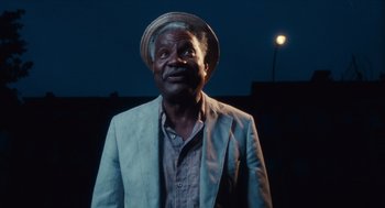 Movie still from “Do the Right Thing” (1989), directed by Spike Lee – An older man wearing a hat and a jacket; Close Up shot, Low angle