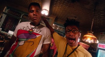 Movie still from “Do the Right Thing” (1989), directed by Spike Lee – Two men posing for a picture in front of a crowd; Medium shot, Low angle