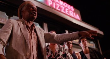 Movie still from “Do the Right Thing” (1989), directed by Spike Lee – A group of people standing in front of a building; Medium shot, Low angle
