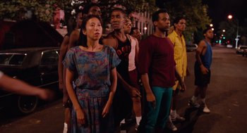 Movie still from “Do the Right Thing” (1989), directed by Spike Lee – A group of men and women standing on a street; Medium shot, High angle