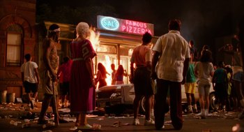 Movie still from “Do the Right Thing” (1989), directed by Spike Lee – A group of people standing outside of a pizza shop; Extreme Wide shot, High angle