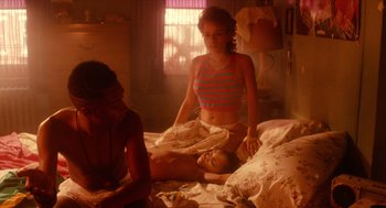 Movie still from “Do the Right Thing” (1989), directed by Spike Lee – Two girls and a boy in a bedroom; Medium shot, High angle