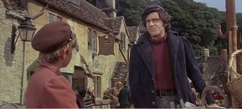 Movie still from “Doctor Dolittle” (1967), directed by Richard Fleischer – A man wearing a hat standing in front of a building; Medium shot, Over the shoulder angle