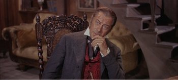 Movie still from “Doctor Dolittle” (1967), directed by Richard Fleischer – A person sitting in a chair wearing a suit; Medium shot, High angle