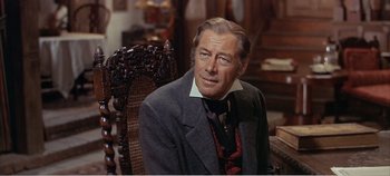 Movie still from “Doctor Dolittle” (1967), directed by Richard Fleischer – A person sitting in a chair wearing a suit; Close Up shot, Over the shoulder angle