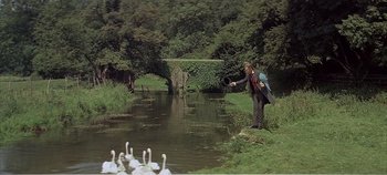 Movie still from “Doctor Dolittle” (1967), directed by Richard Fleischer – A man standing next to a body of water; Wide shot, High angle