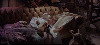 Movie still from “Doctor Dolittle” (1967), directed by Richard Fleischer – A child sleeping on a couch with stuffed animals on it; Medium shot, High angle