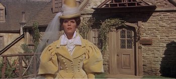 Movie still from “Doctor Dolittle” (1967), directed by Richard Fleischer – A woman in a yellow dress and a hat; Medium shot, Low angle