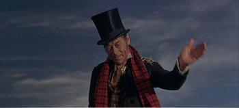 Movie still from “Doctor Dolittle” (1967), directed by Richard Fleischer – A man wearing a top hat and a red scarf; Medium shot, Low angle