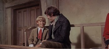 Movie still from “Doctor Dolittle” (1967), directed by Richard Fleischer – Two young men sitting on a bench talking to each other; Medium shot, Over the shoulder angle