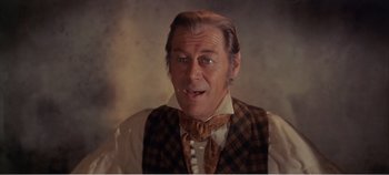 Movie still from “Doctor Dolittle” (1967), directed by Richard Fleischer – An older man wearing a plaid vest and a bow tie; Close Up shot, Over the shoulder angle