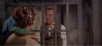 Movie still from “Doctor Dolittle” (1967), directed by Richard Fleischer – An older man in a plaid vest looking through a jail cell; Medium shot, Over the shoulder angle