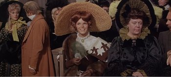 Movie still from “Doctor Dolittle” (1967), directed by Richard Fleischer – A woman with a large straw hat sitting on a chair; Medium shot, High angle