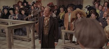 Movie still from “Doctor Dolittle” (1967), directed by Richard Fleischer – An old man standing in front of a group of people; Medium shot, Over the shoulder angle