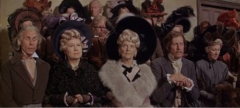 Movie still from “Doctor Dolittle” (1967), directed by Richard Fleischer – A group of people wearing fancy hats in a crowd; Medium shot, High angle