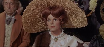 Movie still from “Doctor Dolittle” (1967), directed by Richard Fleischer – A person wearing a hat and a dress; Close Up shot, Over the shoulder angle