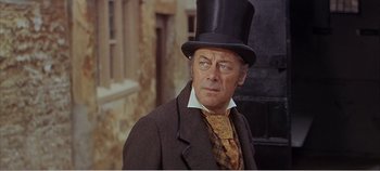 Movie still from “Doctor Dolittle” (1967), directed by Richard Fleischer – An older man wearing a top hat and a suit; Close Up shot, Low angle