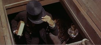 Movie still from “Doctor Dolittle” (1967), directed by Richard Fleischer – A man in a black suit and a black hat; Close Up shot, Overhead angle