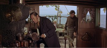 Movie still from “Doctor Dolittle” (1967), directed by Richard Fleischer – A man in a brown coat and a woman in a brown sweater; Medium shot, High angle