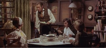 Movie still from “Doctor Dolittle” (1967), directed by Richard Fleischer – A group of people sitting around a table eating; Medium shot, High angle